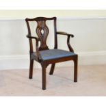 An early George III mahogany elbow chair the foliate carved yoke top rail and pierced vase splat,