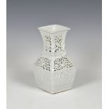 A Chinese square baluster reticulated vase probably 20th century, white glaze, the neck with applied