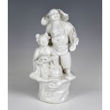 A Chinese porcelain blanc-de-chine figural group of Buddha and attendant the Buddha modelled