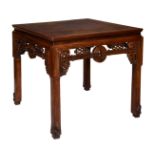 A large Chinese square hardwood table probably 19th century, the cleated top with a pierced apron