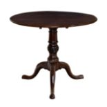 A George III mahogany circular tilt-top tripod table the well figured top on a spiral fluted,