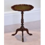 A Georgian style mahogany wine table late 20th century, the shaped top with inset green, gilt tooled