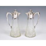 A pair of early 20th century German silver mounted cut glass claret jugs in the Art Nouveau