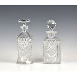 Two cut glass decanters the first thistle shaped with mushroom stopper and star-cut base, the