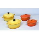 Four Le Creuset cast iron oval casserole dishes two yellow, measuring 11 & 10in., and two others