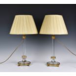 A pair of gilt metal and cut glass candlestick lamps the hexagonal tapering glass column to circular