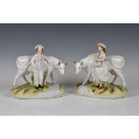 A pair of Victorian Staffordshire figures of a boy and milkmaid with cows both white glazed with