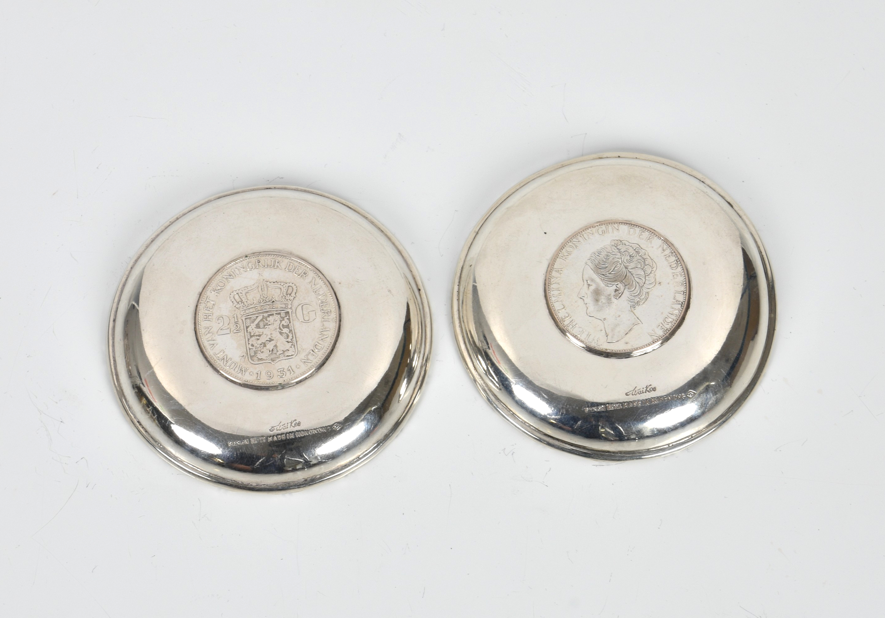 A pair of Hong Kong silver pin dishes by Wai Kee, with inset 1933 Dutch 2½ guilder coins, 3½in. (8.