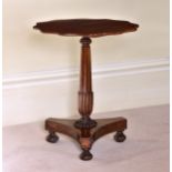 A William IV mahogany occasional or wine table the scalloped top on a part-reeded, turned column