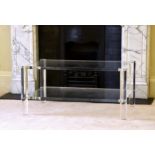 A modernist clear acrylic two-tier coffee table 1980s-90s, the two rectangular tiers on tubular