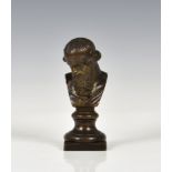 A Grand Tour gilt bronze bust of Dionysus 18th century, traces of gilt remaining, on a waisted socle