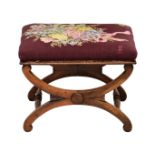 A Regency rosewood foot stool with tapestry seat the cross frame supports with turned stretchers,