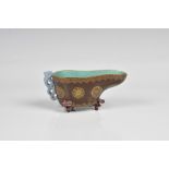 A Chinese 19th century brown glazed and gilt decorated libation cup with lavender glazed feet and