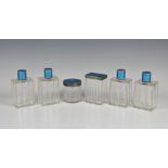 A six piece French silver and guilloche enamel toilette set each having ribbed design to clear glass