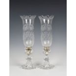 A pair of Baccarat glass hurricane lamps with etched shades wrythen-fluted base, the removable