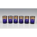 A set of six Bohemian blue and gilt water glasses 1950s-60s, the tapered, cylindrical glasses with