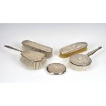 A three piece silver chinoiserie style dressing table set marked sterling, to include hairbrush,