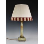 A onyx and gilt bronze table lamp of typical form, the square base, raised on four ball feet, height