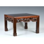 A Chinese hardwood low, square stand or table late 19th / early 20th century, the cleated top with a