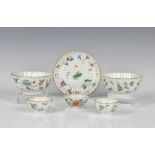 A pair of Chinese famille rose miniature tea bowls 19th century, scalloped gilt rims, painted with