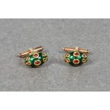 A pair of rose gold, ruby and enamel cufflinks of scarab style form, green enamel ground, with