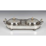 A 19th century silver plated two-dish food warming stand of oval form with twin foliate cast and