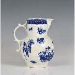 A first period Worcester leaf moulded mask jug blue and white printed with parrot pecking fruit on
