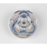 A Baccarat facetted / patterned millefiori glass paperweight the clear glass set with a trefoil