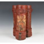 A triple cylindrical red canvas covered ammunition / cartridge case stick stand each with painted