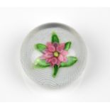 A St. Louis Clematis glass paperweight c.1850, the swirling white latticinio ground supporting a