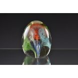 A 1950's Murano glass paperweight of oval egg shaped form with coloured spiral twist flowers, 4 5/