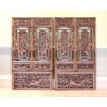 Two pairs of Chinese carved and pierced hardwood window shutters probably early 20th century, the