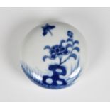 A Chinese blue & white circular seal paste box and cover painted with a peony and butterfly, twin