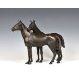 A modern patinated bronze of two horses unmarked, 17in. (43.2cm.) long, 11½in. (29.3cm.) high.*