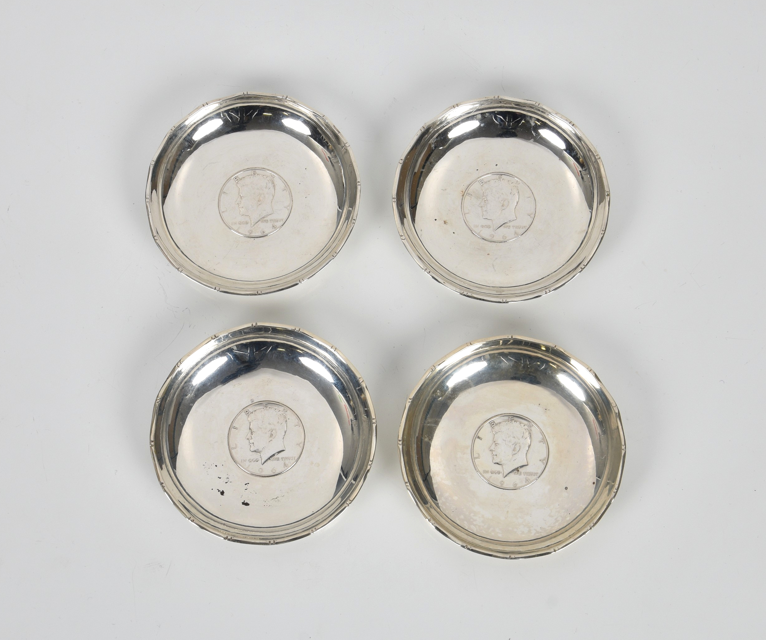 A set of four Hong Kong silver pin dishes by Wai Kee, with inset HK junk dollar coins, 3½in. (8.