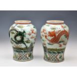A pair of Chinese famille verte baluster dragon vases 20th century with earlier Kangxi marks,