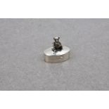 A silver teddy bear pill box, marked '925', the oval box with a miniature figure of a seated bear