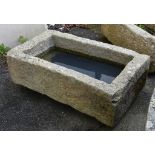 A weathered rectangular granite trough, 37½ x 21¼in. (95.2 x 53.9cm.). *