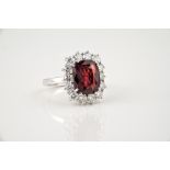 A fine 18ct white gold, unheated Siamese ruby and diamond cluster ring