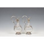 A pair of elegant rococo style French silver mounted claret jugs, by Claude Doutre Roussel, 1st half
