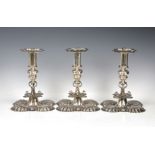 A matched set of three elaborate Edwardian silver candlesticks in the Carolean style, Crichton