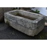 A weathered rectangular granite trough, 39 x 24in. (109.2 x 60.9cm.). *