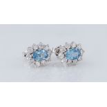 A pair of 18ct white gold, aquamarine and diamond cluster earrings, the two oval cut aquamarines,