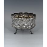 A footed Indian silver bowl, of shaped circular lobed form, raised on three entwined fish feet, with