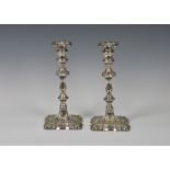 A pair of George II style Edwardian silver weighted candlesticks, Thomas Bradbury & Sons Ltd,
