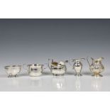 A collection of various antique silver collectables, to include a cream jug of bulbous pedestal form