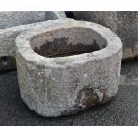 A weathered oval granite trough, 25 x 21in. (63.5 x 53.3cm.). *