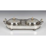 A 19th century silver plated two-dish food warming stand, of oval form with twin foliate cast and