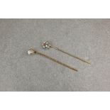 A boxed 9ct gold and paste stick pin, together with a silver, 9ct gold and paste stick pin with