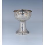 An Arts and Crafts planished silver chalice, Harrods Stores Ltd (Richard Burbridge), London 1914, of